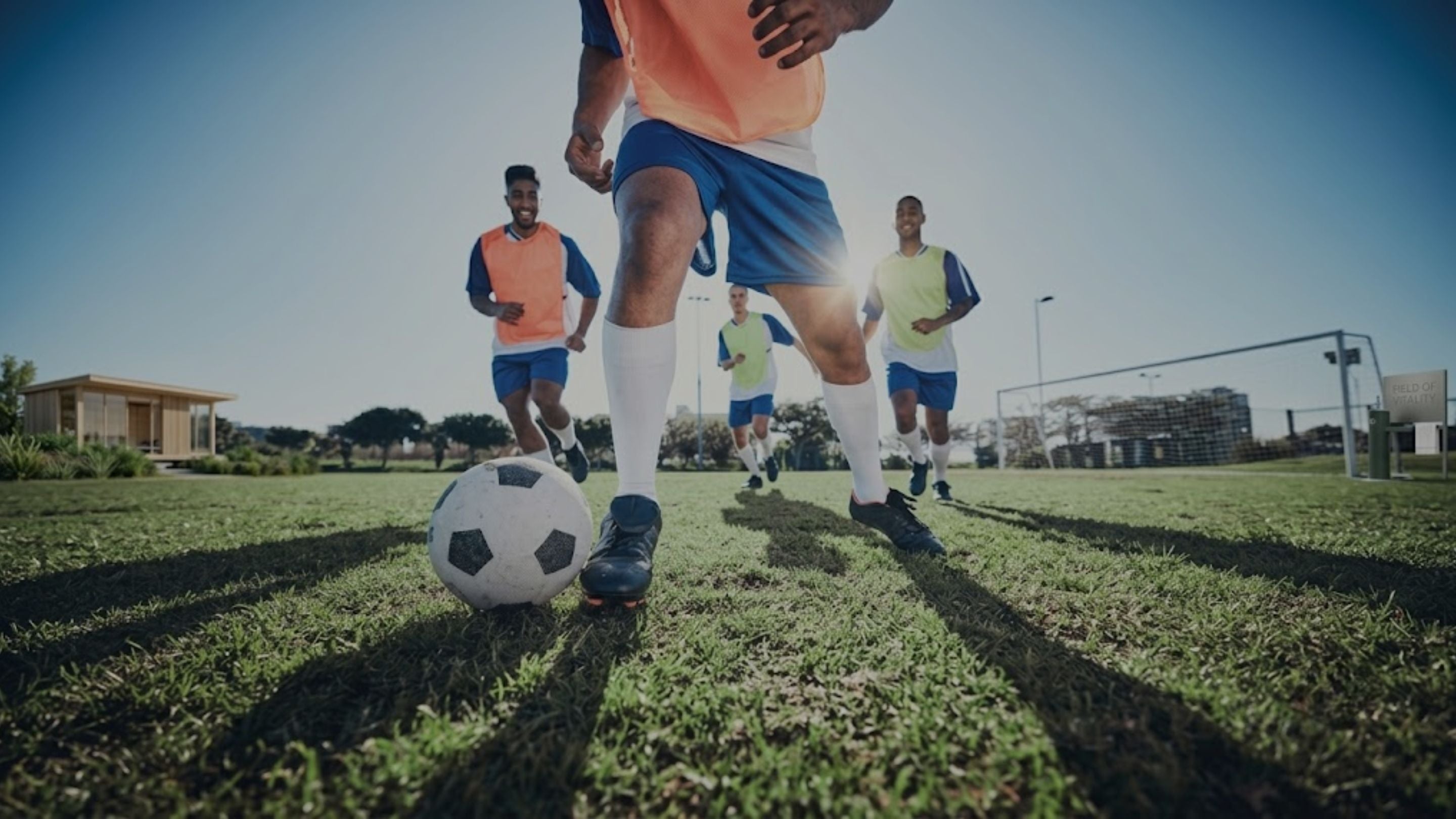Soccer players practicing ball control during outdoor team training match session.
